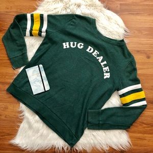 green, white, and yellow long sleeve/sweater